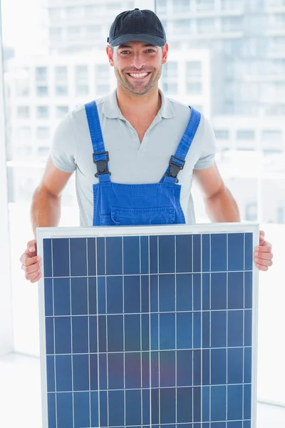 Sorrindo faz-tudo segurando painel solar — Fotografia de Stock