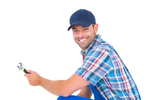 Portrait of happy handyman holding wrench — Stock Photo, Image
