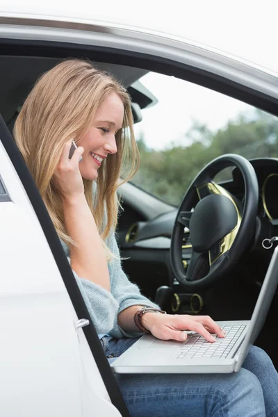 Young woman working in the drivers seat — Stock Photo, Image