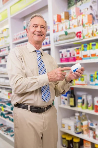 Smiling customer showing a medicine — Stock Photo, Image