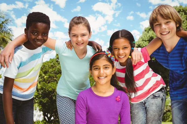 Happy children forming huddle at park — Stock Photo, Image