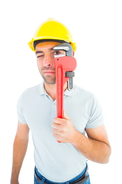 Manual worker looking through monkey wrench — Stock Photo, Image