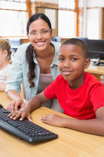 Cute pupil in computer class with teacher — Stock Photo, Image