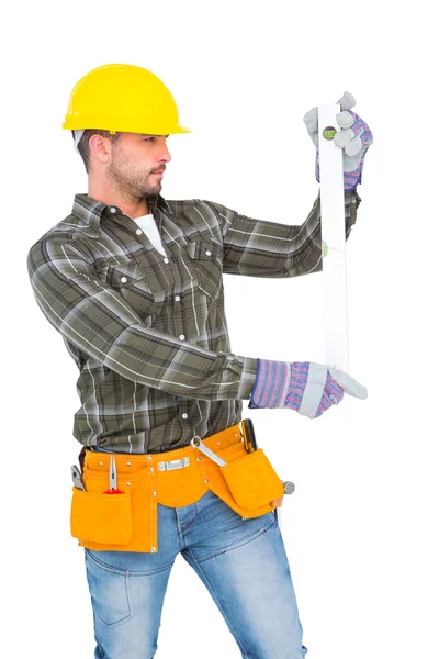 Serious handyman using spirit level — Stock Photo, Image