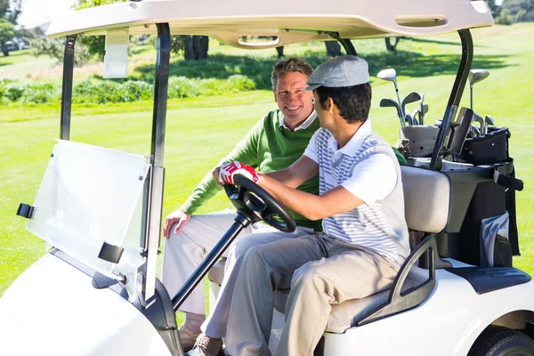 Amis de golf conduisant dans leur buggy de golf — Photo