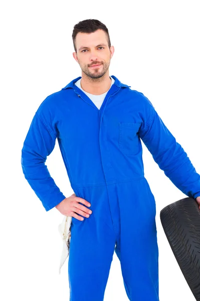 Smiling male mechanic holding tire — Stock Photo, Image