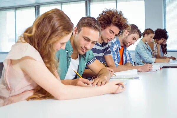 Fashion students taking notes in class — Stock Photo, Image