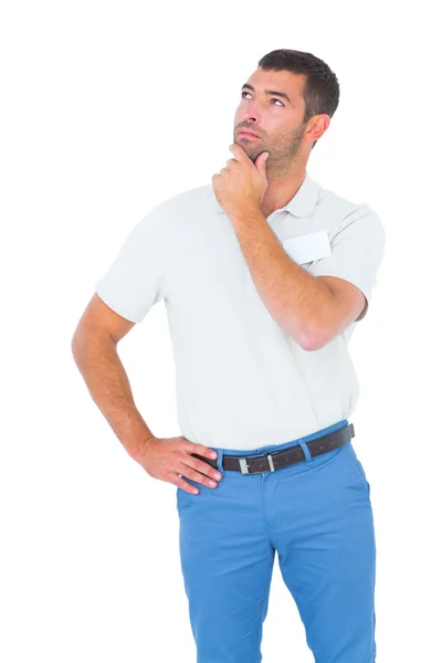 Technician with hand on chin looking up over white background — Stock Photo, Image