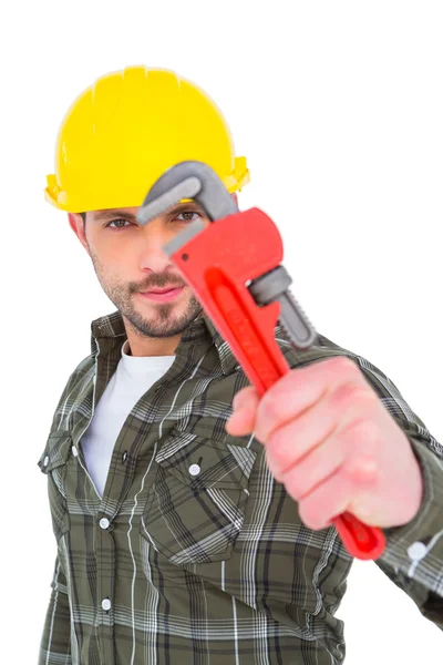 Manual worker looking through monkey wrench — Stock Photo, Image