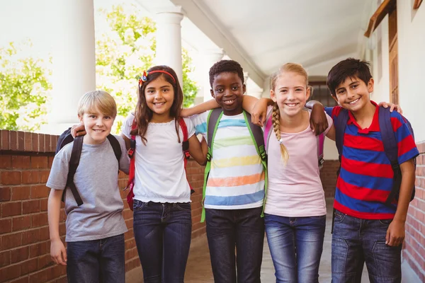 Smiling little school kids in school corridor — Stock Photo, Image