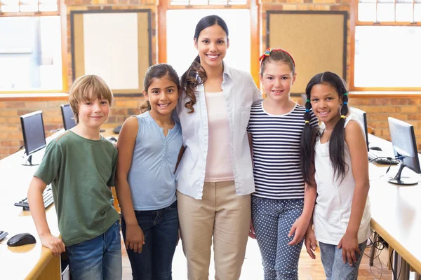 Cute pupils and teacher smiling — Stock Photo, Image