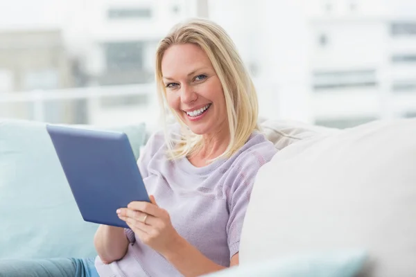 Vrouw met behulp van tablet pc op Bank — Stockfoto