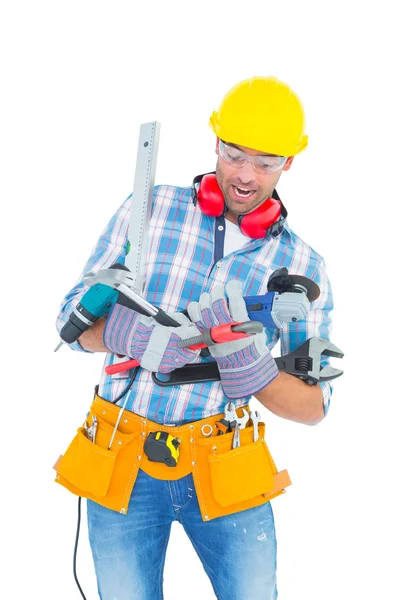 Manual worker balancing various tools Stock Picture