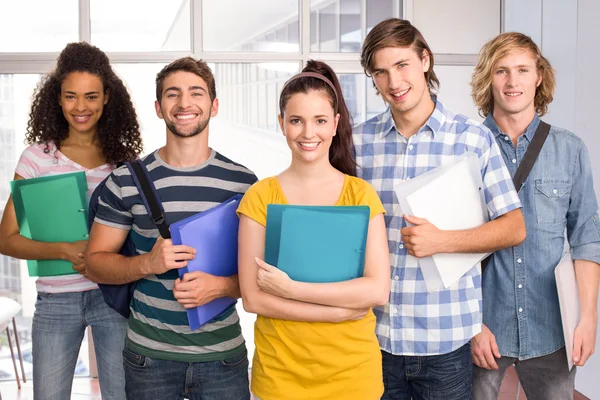 Students holding folders in college Royalty Free Stock Images