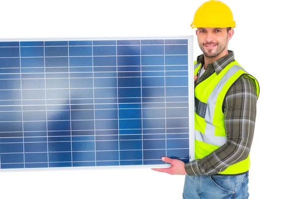 Handyman carrying solar panel — Stock Photo, Image