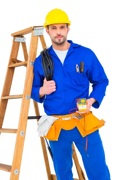 Electrician holding cables and multimeter — Stock Photo, Image