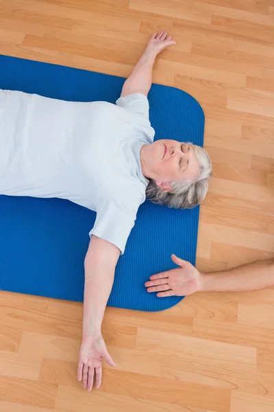 Seniorin liegt auf Gymnastikmatte — Stockfoto