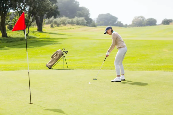 Ženský golfer uvedení její míč — Stock fotografie