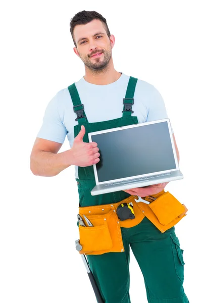 Trabalhador da construção sorrindo segurando laptop — Fotografia de Stock