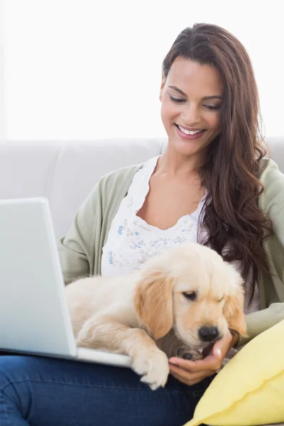 Mujer con perro usando portátil en sofá — Foto de Stock