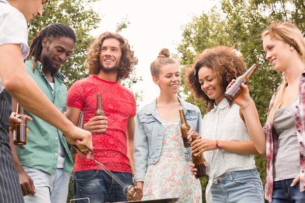 Felices amigos en el parque teniendo barbacoa —  Fotos de Stock