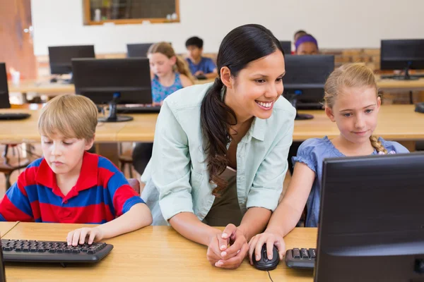 Allievi carini in classe di computer con insegnante — Foto Stock