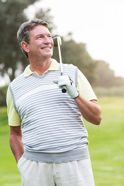 Golfer standing and swinging his club — Stock Photo, Image