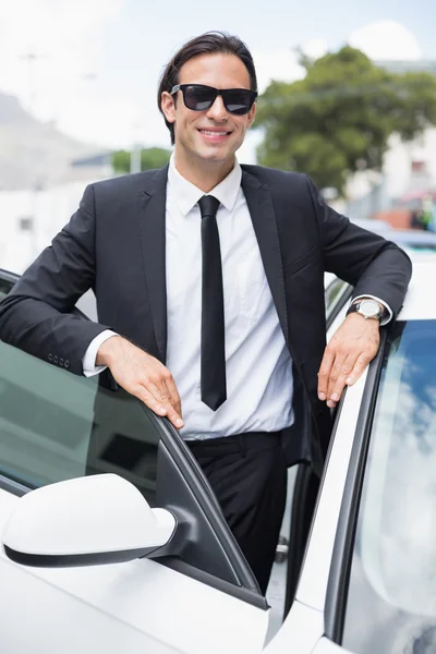 Businessman leaning on the door — Stock Photo, Image