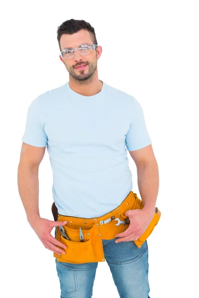 Smiling handyman with hands on hips — Stock Photo, Image