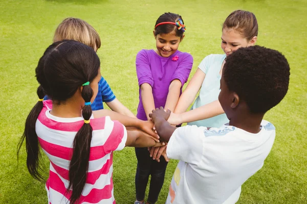 Children holding hands together at park — Stock Photo, Image