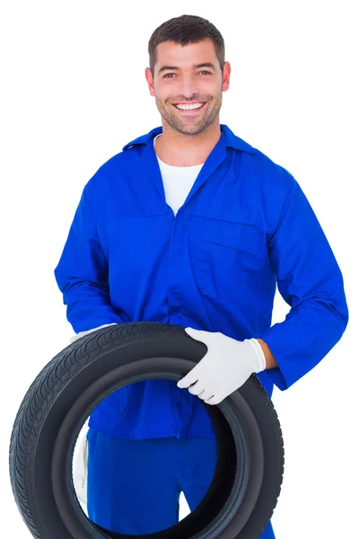 Mechanic holding tire — Stock Photo, Image