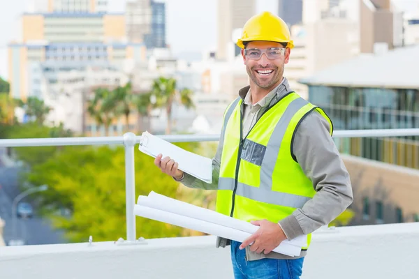 Architect with blueprints and clipboard — Stock Photo, Image
