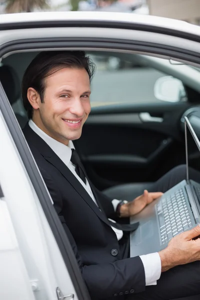 Businessman working in drivers seat — Stock Photo, Image