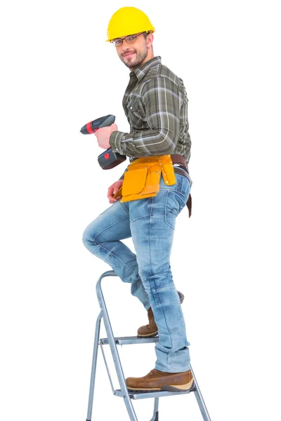 Repairman with drill machine climbing ladder — Stock Photo, Image