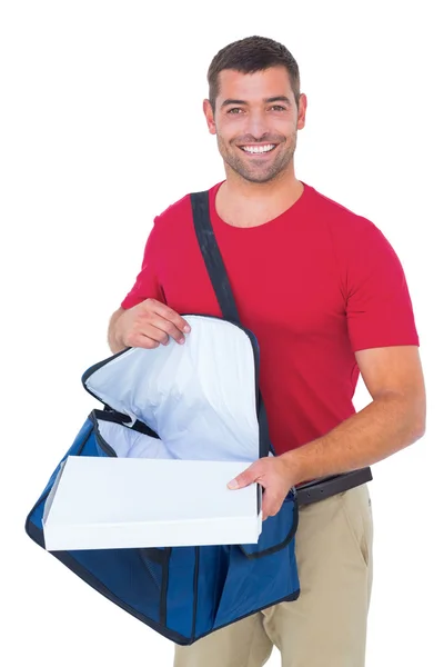 Delivery man removing pizza box from bag — Stock Photo, Image