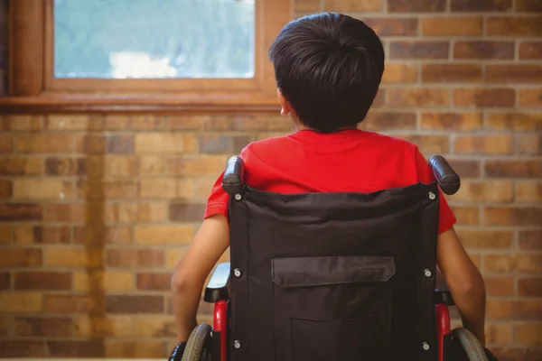 Rear view of boy sitting in wheelchair — Stock Photo, Image