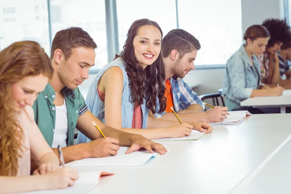 Estudiante de moda sonriendo a la cámara en clase — Foto de Stock