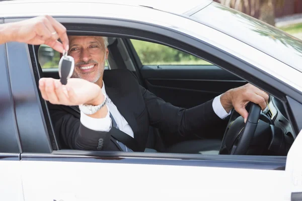 Handsome businessman in the drivers seat — Stock Photo, Image