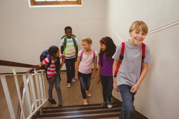 School kids walking up stairs in school — Stock Photo, Image