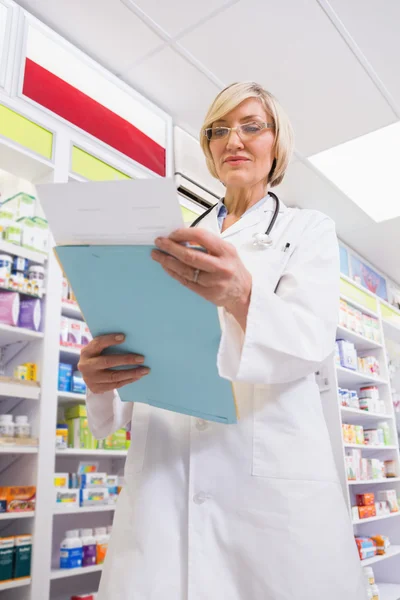 Concentrated doctor reading a prescription — Stock Photo, Image