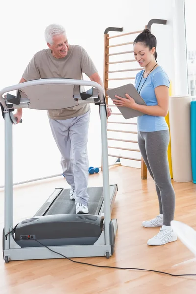 Hombre mayor haciendo ejercicio con su entrenador —  Fotos de Stock