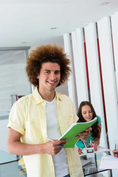 Portrait of smiling casual man with file — Stock Photo, Image