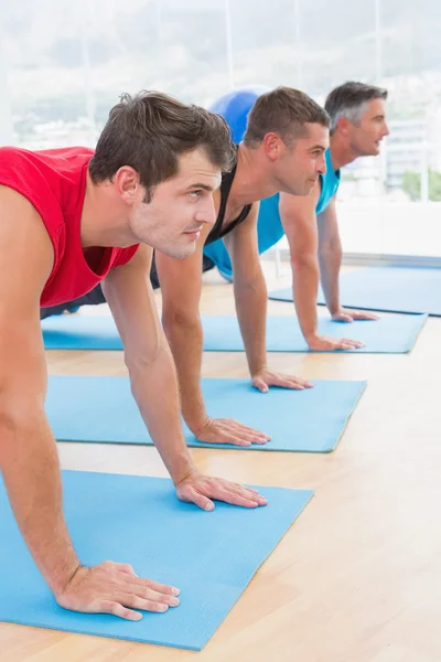 Grupo de homens que trabalham no tapete de exercício — Fotografia de Stock