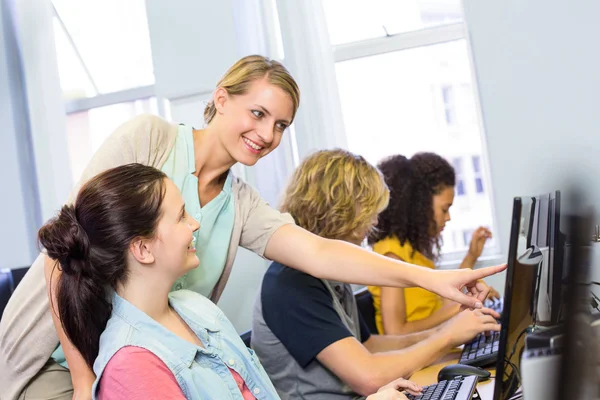 Computer docent helpen vrouwelijke studenten — Stockfoto