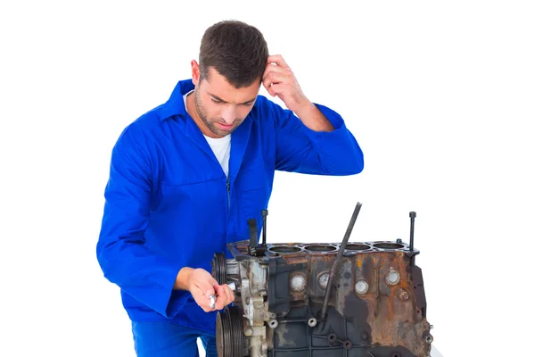 Confused mechanic repairing car engine — Stock Photo, Image