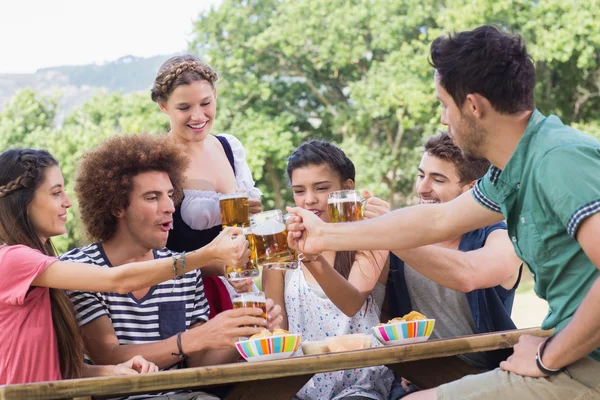 Pretty oktoberfest girl serving friends — Stock Photo, Image