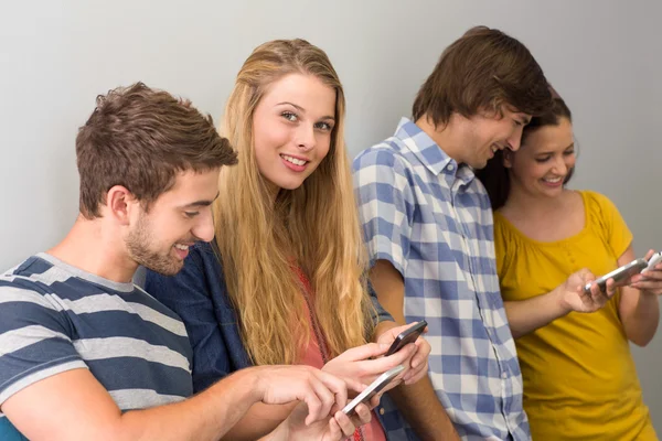 Estudiantes universitarios usando teléfonos celulares —  Fotos de Stock