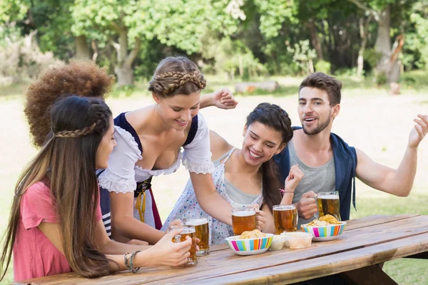 Pretty oktoberfest girl serving friends — Stock Photo, Image