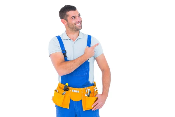 Repairman in overalls pointing — Stock Photo, Image