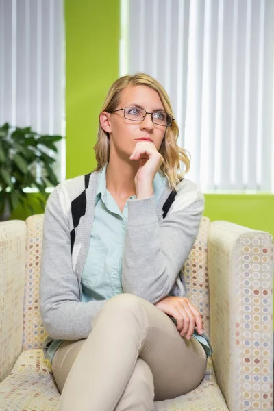 Pretty student thinking in library — Stock Photo, Image